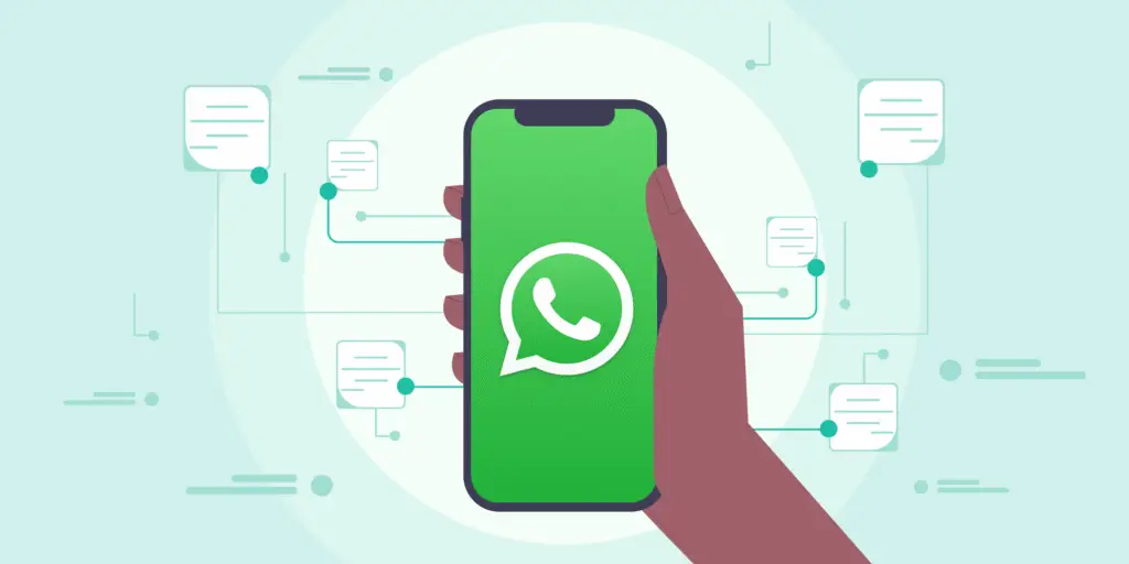 Mano sosteniendo un móvil con el logotipo de WhatsApp rodeado de mensajes automáticos